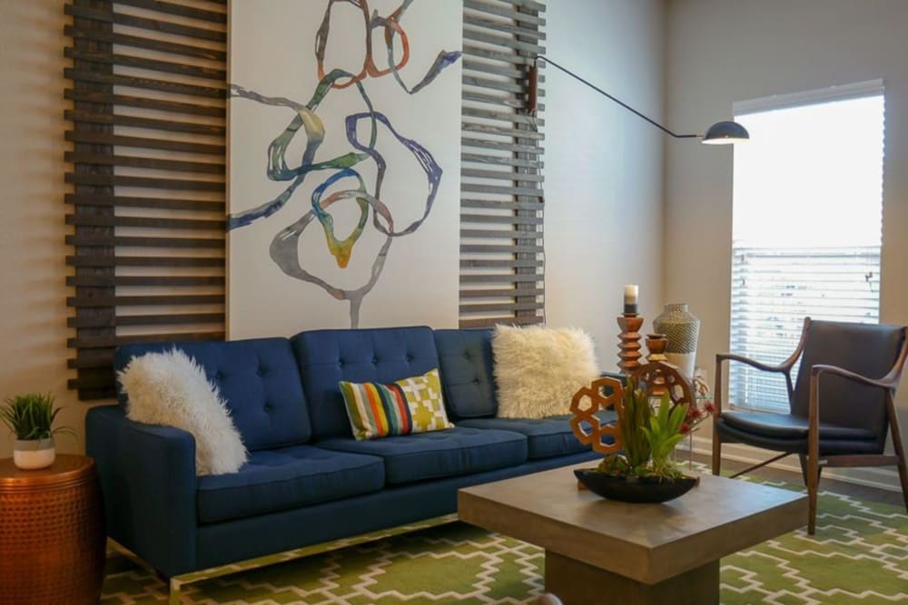 Model living room with bright decor at Biltmore at the Park in Pflugerville, Texas