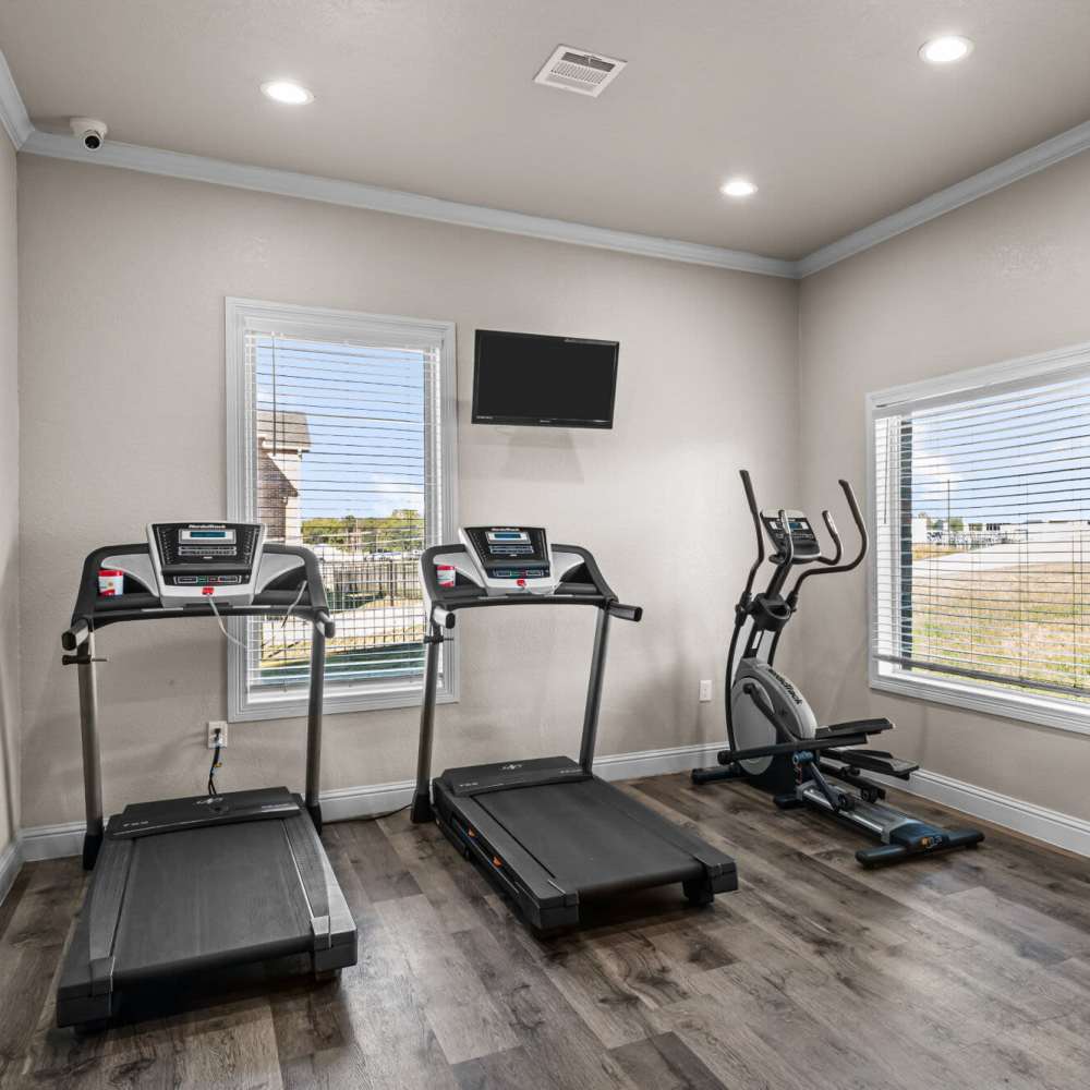 Fitness center with treadmill at The Arbors of Mineola in Mineola. TX