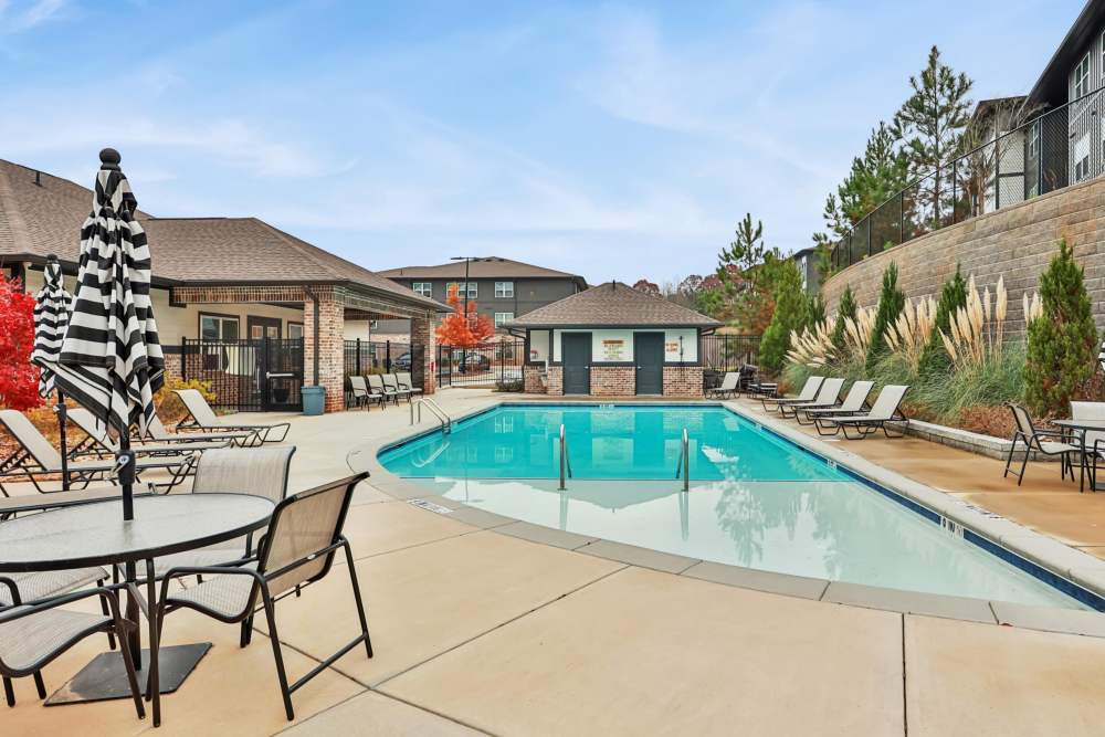 A view of the swimming pool with sun shade at Flats at Mount Zion in Stockbridge, Georgia