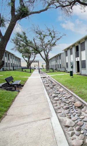 Walking path and bench in the courtyard at Vista Verde in Mesquite, Texas