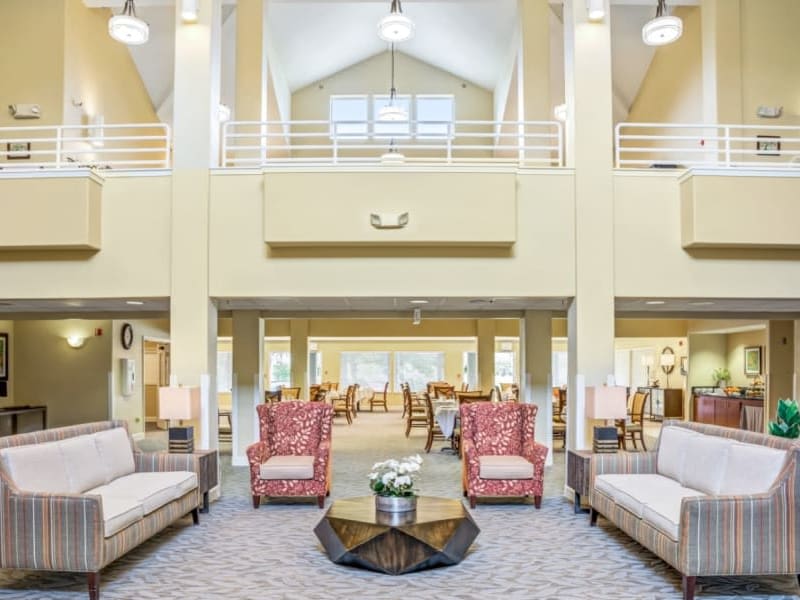 Elegant and well lit lobby with seating at Woodside Senior Living in Springfield, Oregon