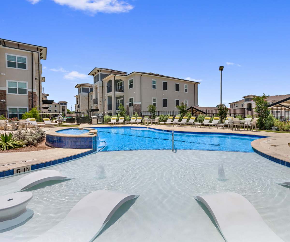 Swimming pool with lounge beds at Sadler House in San Marcos, Texas