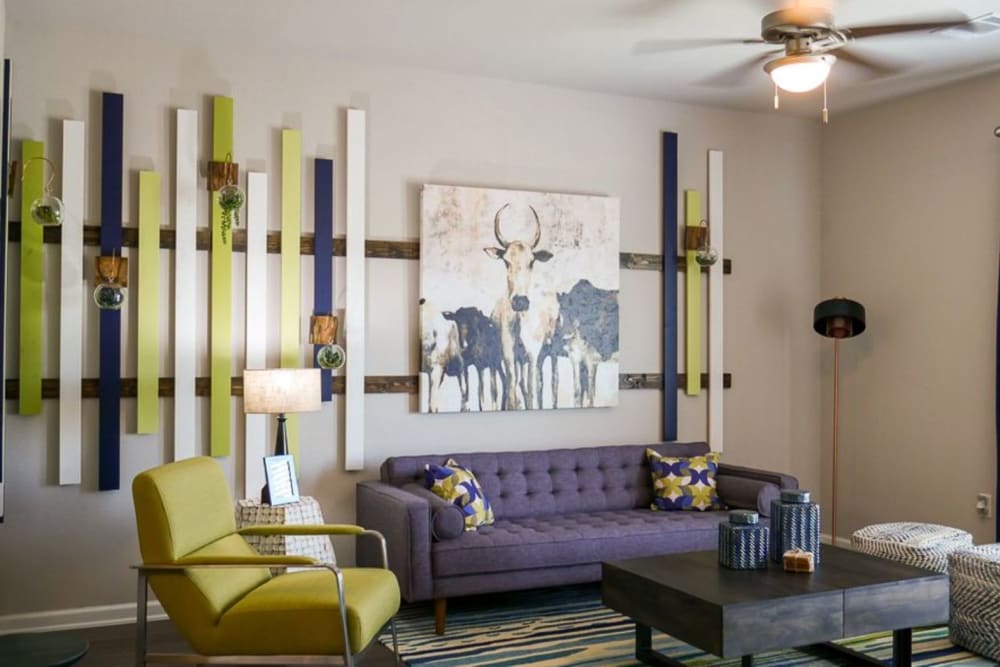 Model living room with eclectic wall art at Biltmore at the Park in Pflugerville, Texas