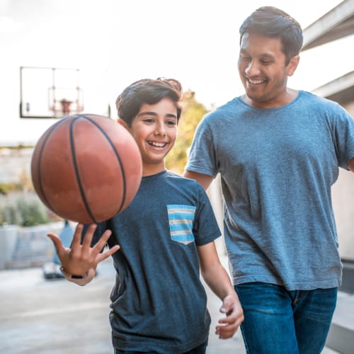 A father and son walking with a basketball at Capeharts in Ridgecrest, California