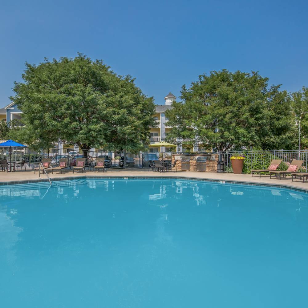 Swimming pool with trees at One Belmar Place in Lakewood, Colorado