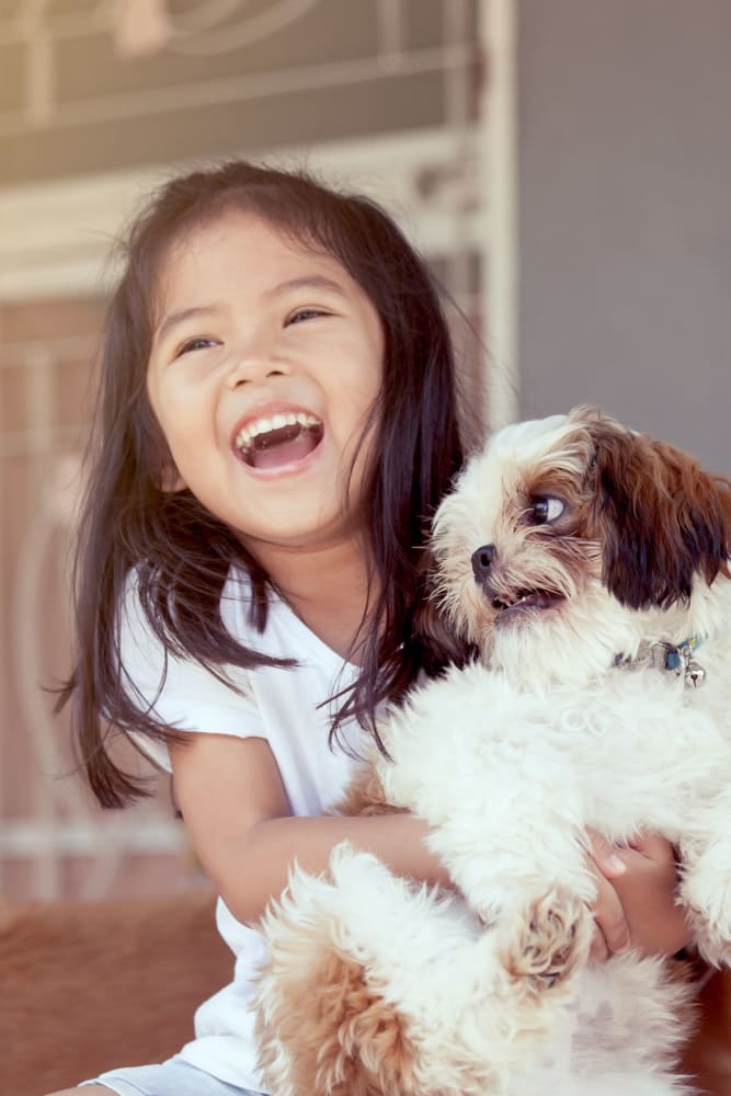 Resident child holding her pup in their home at The Armory in Bethlehem, Pennsylvania