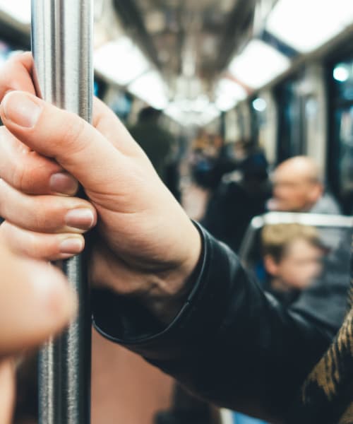 Woman on a train in Baltimore, MD near Calloway Row Apartments