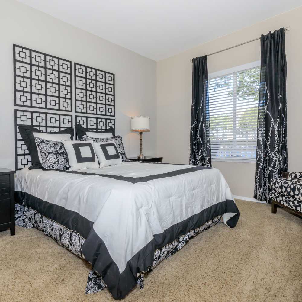 Specious bedroom with side lamp at One Belmar Place in Lakewood,Colorado