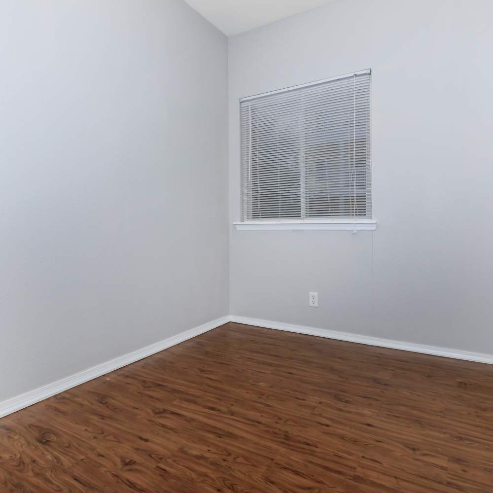 Unfurnished bedroom with wood-style flooring at One Belmar Place in Lakewood,Colorado