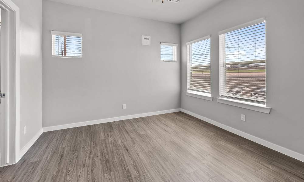 Unfurnished living room with two large window and wood-style flooring at Retreat at Horizon Hills in El Paso, Texas