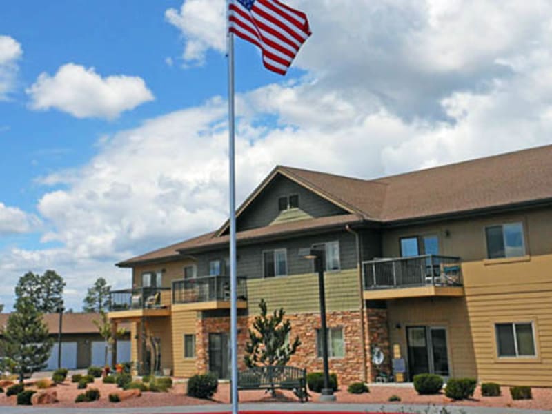 The front entrance of a senior living facility on a sunny day at Majestic Rim Retirement Living in Payson, Arizona.