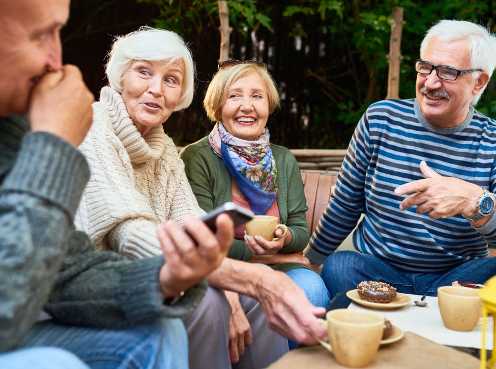 Residents having a fun conversation outside at Touchmark Central Office in Beaverton, Oregon