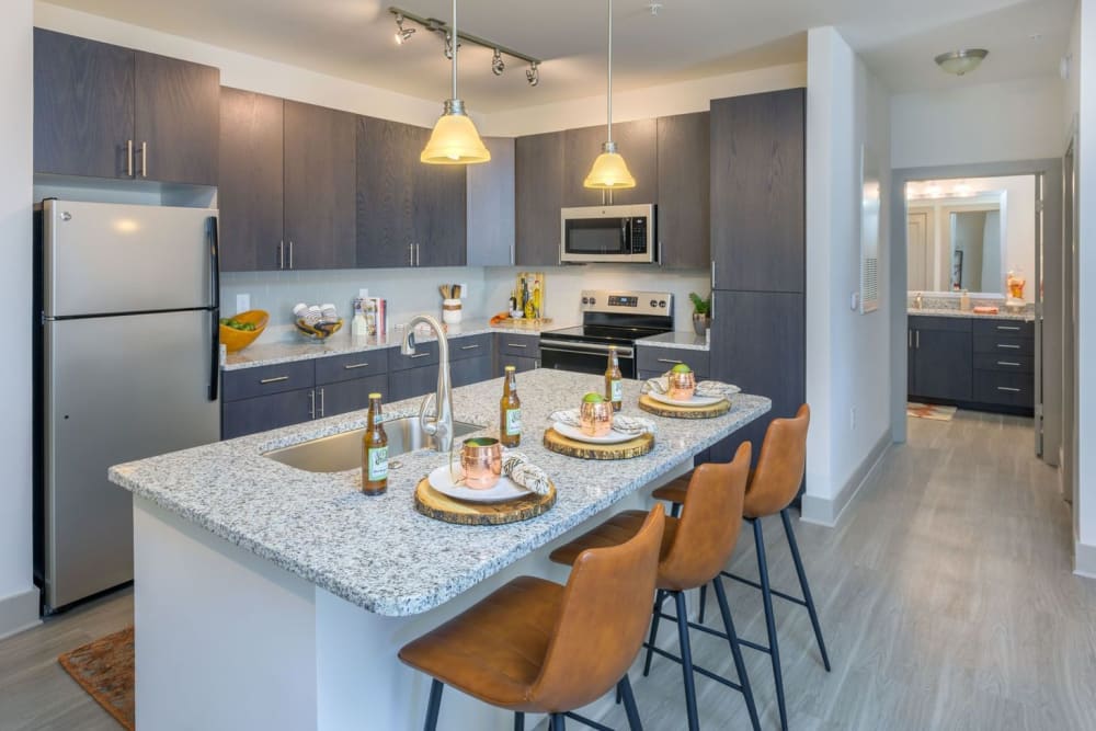 Gourmet kitchen with a large island and granite countertops at Haven at Rivergate in Charlotte, North Carolina