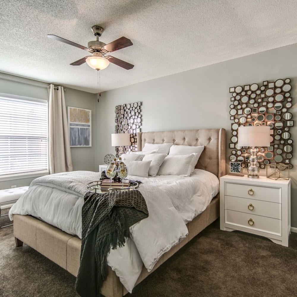 Modern style bedroom with lots of sunshine at London House Apartments in Lenexa, Kansas