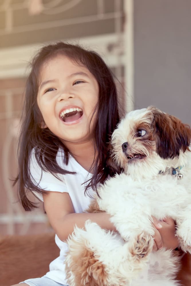 Child with her pup in their home at The Seville Apartments in Easton, Pennsylvania