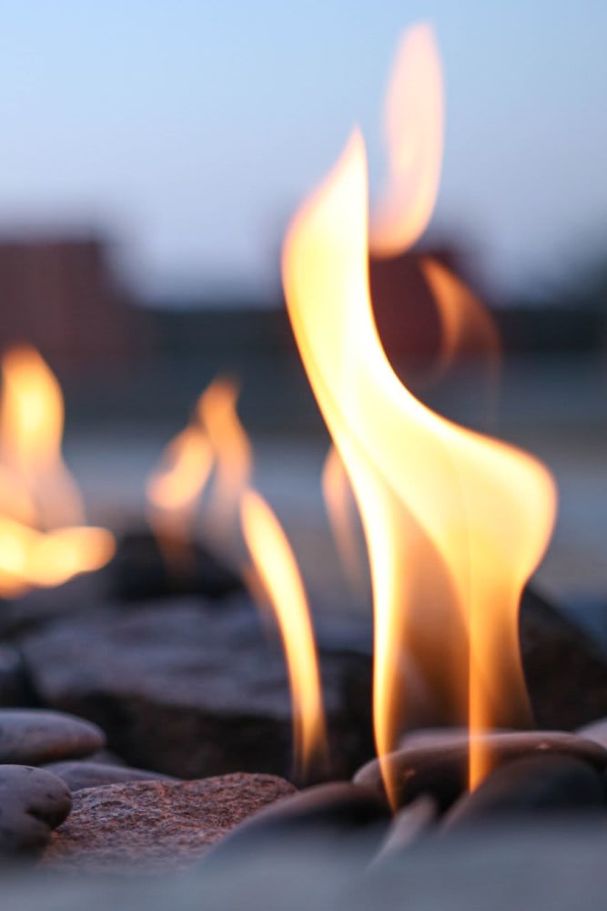 A firepit on the rooftop terrace at 55 Brighton at Packard Crossing in Boston, Massachusetts