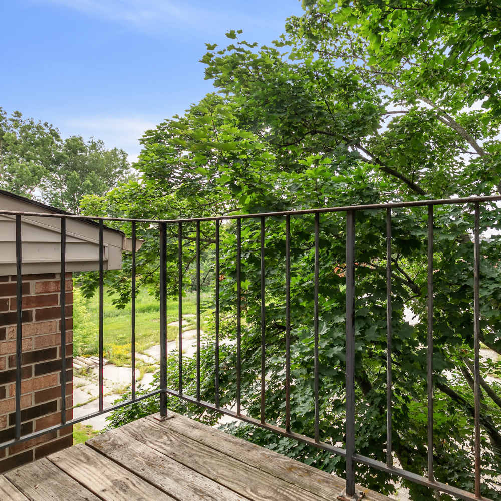 Private balcony with wooden plank flooring at Prairie Apartments in Salem,Wisconsin
