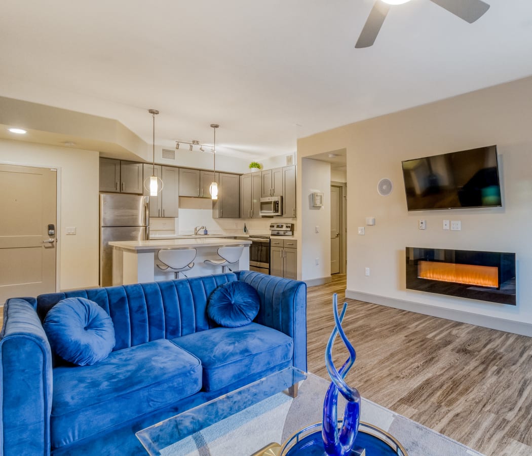 Living room with electric fireplace at Enchanted Springs Apartments in Colorado Springs, Colorado