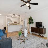 Living room with ceiling fan at Evergreen at Five Points in Valdosta, Georgia
