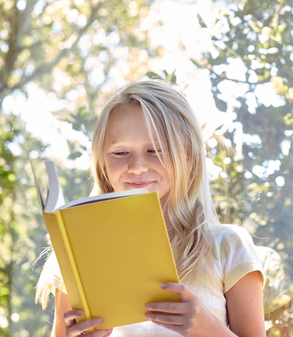 Resident child reading a book in her new home at Waterstone Fremont in Fremont, California