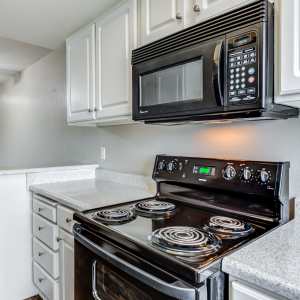 Kitchen with black appliances at Legacy at Westglen in Glendale, California