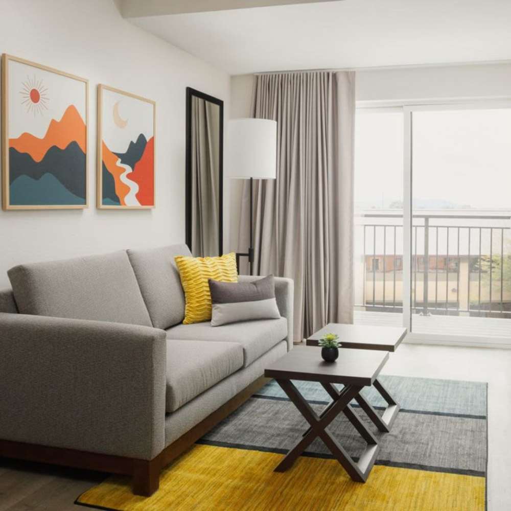 Modern living room with sofa and balcony at WaterWalk Jacksonville - Deerwood Park in Jacksonville, Florida
