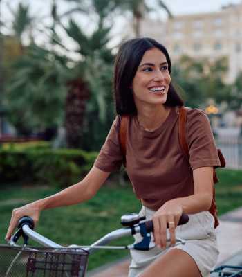 A resident father riding her bike at Pecan Villa Apartments in Houston, Texas