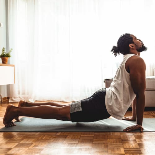 Resident doing some living room yoga at Marquis at Chandler in Chandler, Arizona