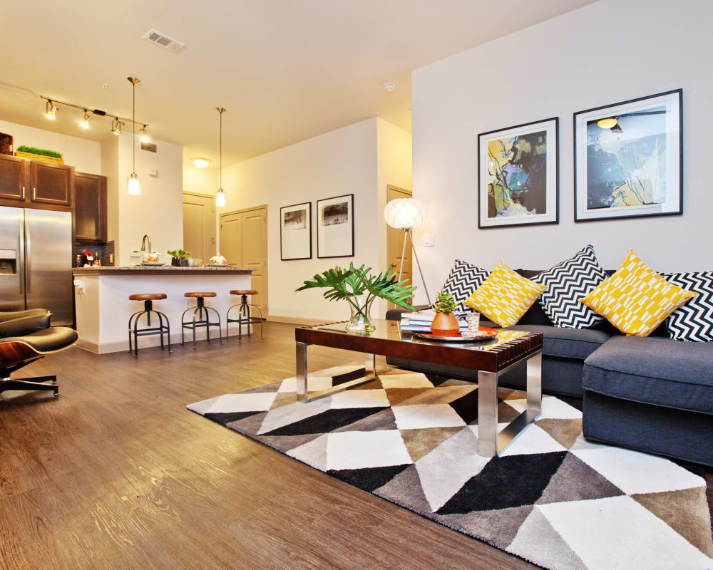 Wood-style vinyl flooring in a model living room at Olympus Auburn Lakes in Spring, Texas