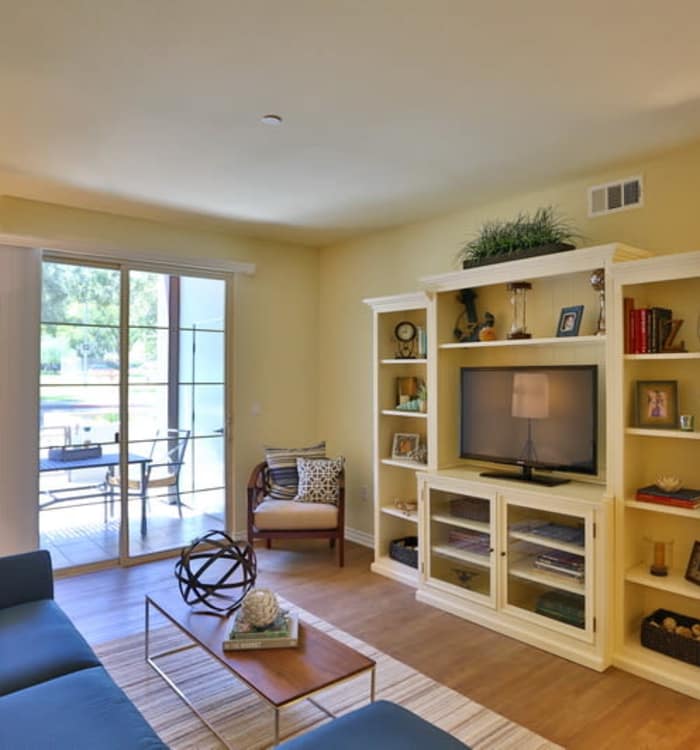 Model home living room looking out onto private balcony at IMT Park Encino in Encino, CA