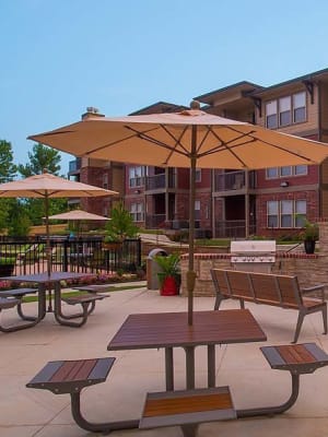 Picnic area seating with umbrella at Icon at Broken Arrow in Broken Arrow, Oklahoma