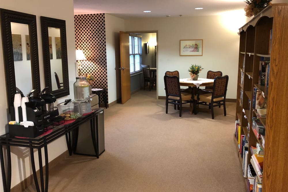 Wide, well lit hallway complete with game shelf at HeatherWood Assisted Living & Memory Care in Eau Claire, Wisconsin. 
