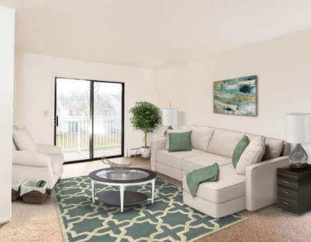 Bright, well decorated living room at Penbrooke Meadows in Penfield, New York