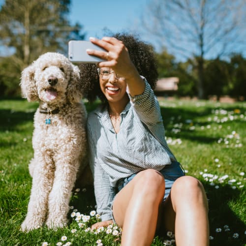 Woman taking a selfie with her dog in a park near Fusion in Jacksonville, Florida