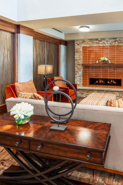 Upscale lounge with a fireplace at Quail Park of Oro Valley in Oro Valley, Arizona
