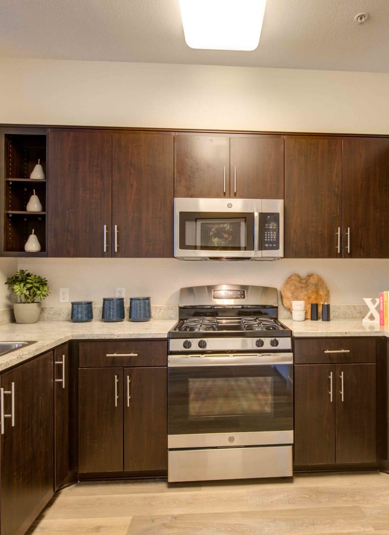 Modern kitchen with sleek, stainless-steel appliances in a model home at Sofi Warner Center in Woodland Hills, California