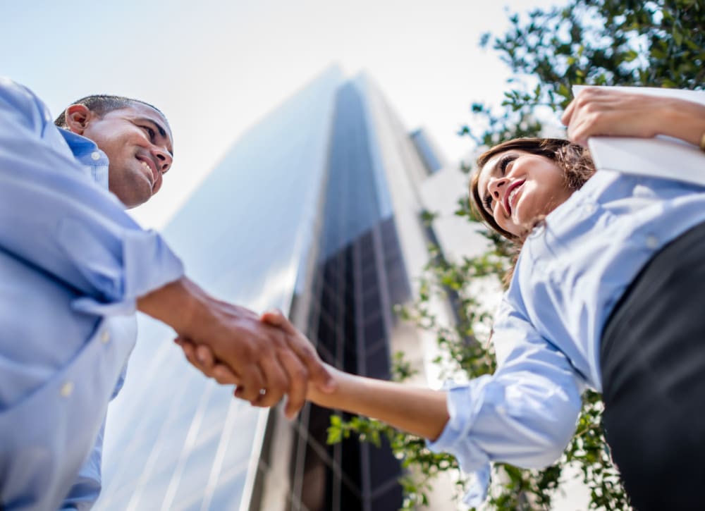 A savvy investor shaking hands with a senior executive outside our corporate office at Electra America in Lake Park, Florida
