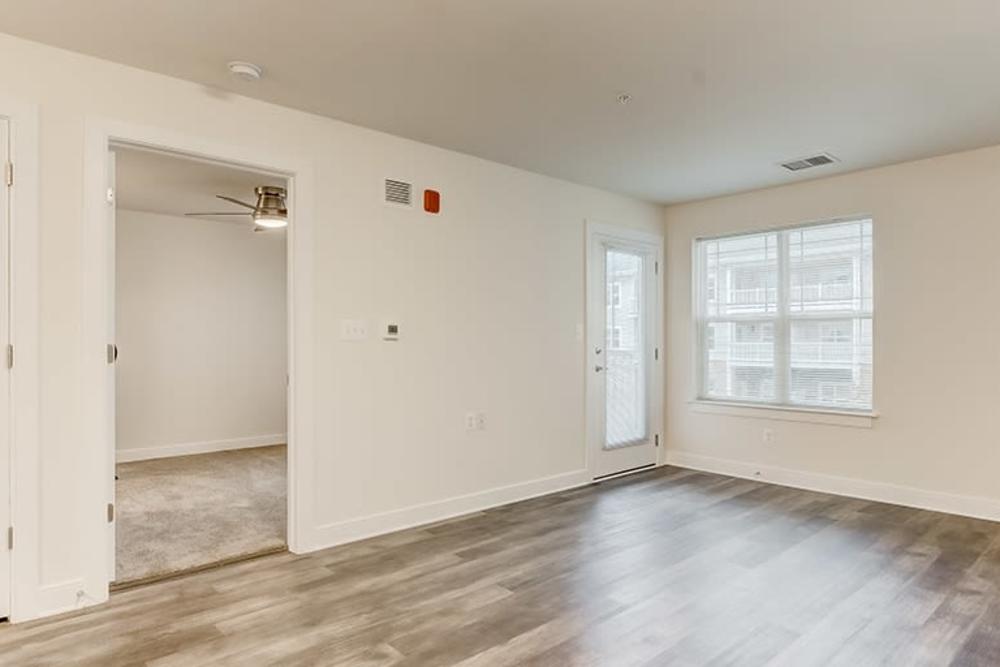 Open layout living room with wood-style flooring at Homes on Quaker Lane in Sandy Spring, Maryland