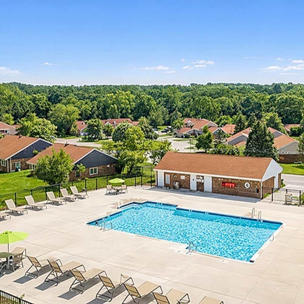 Resort-style pool with lounge chairs at 83 West Townhomes in West Bloomfield Township, Michigan