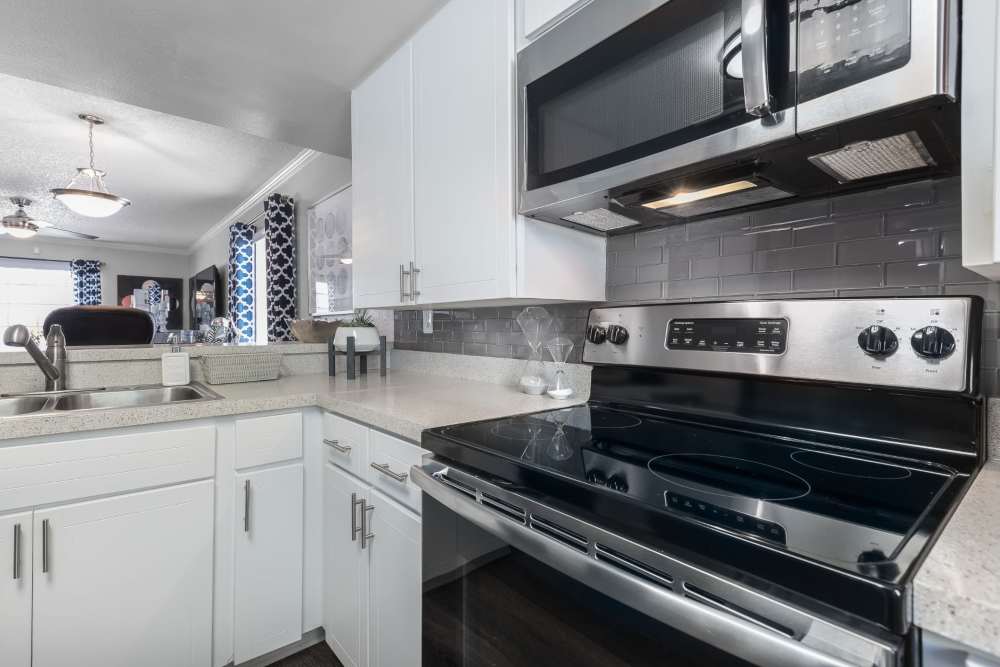 Modern apartment kitchen with white counters and cabinet at Barrington Place at Winter Haven in Winter Haven, Florida