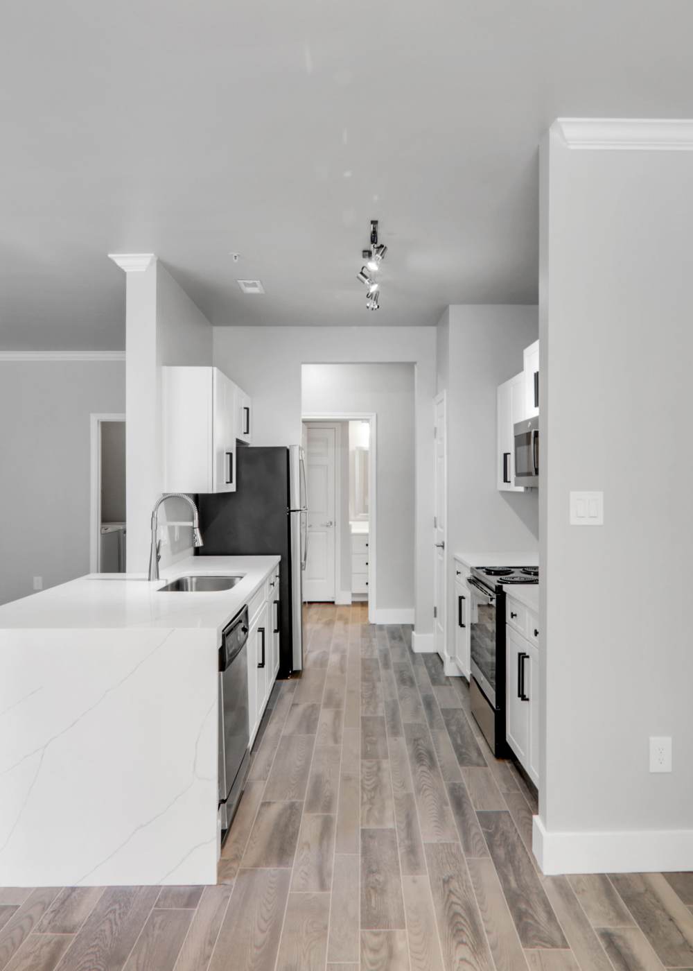 Dining area with view to apartment kitchen at Wesley in Raleigh, North Carolina