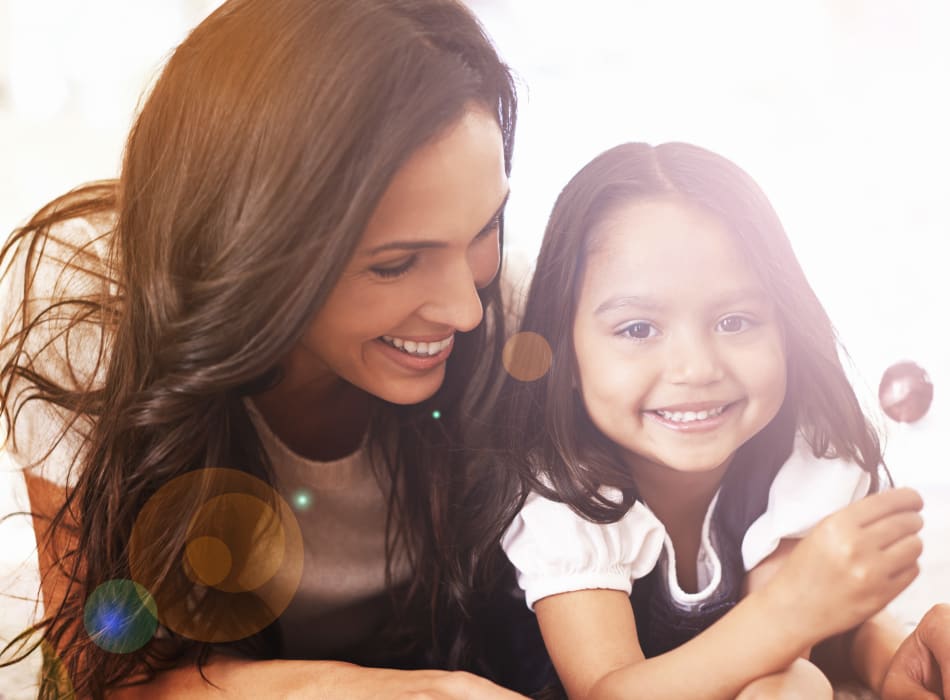 Mother and daughter lying on the ground together at Sofi Danvers in Danvers, Massachusetts