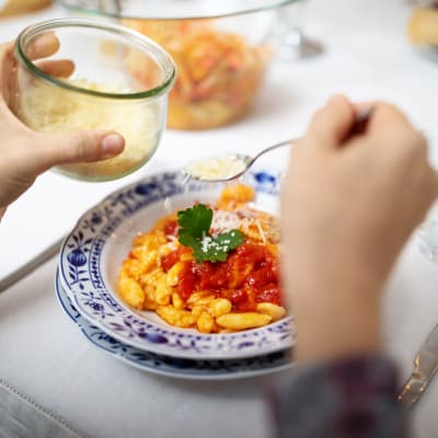 Resident eating a pasta dish at York Gardens in Edina, Minnesota