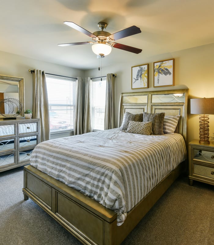 Spacious carpeted bedroom at Cottages at Abbey Glen Apartments in Lubbock, Texas