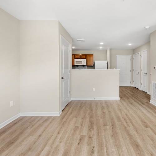 Spacious living room with lvt flooring at Deville Manor in Oswego, Illinois