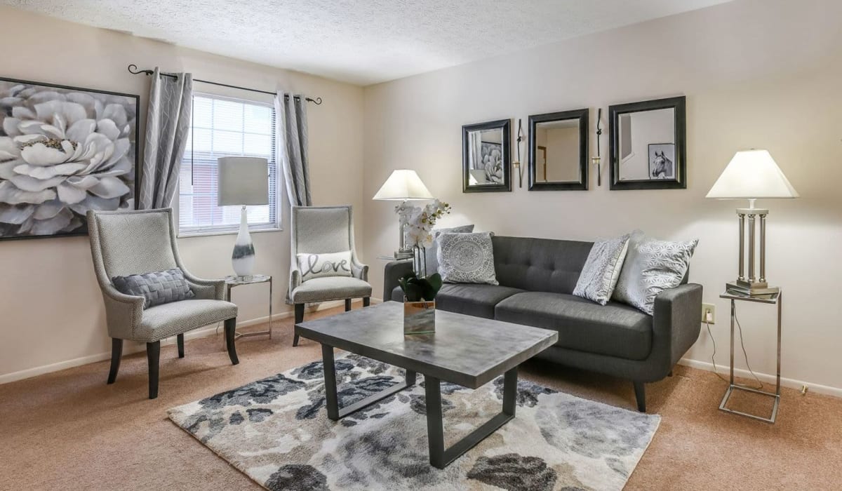 Modell living room with wall-to-wall carpeting at Pointe at Northern Woods in Columbus, Ohio