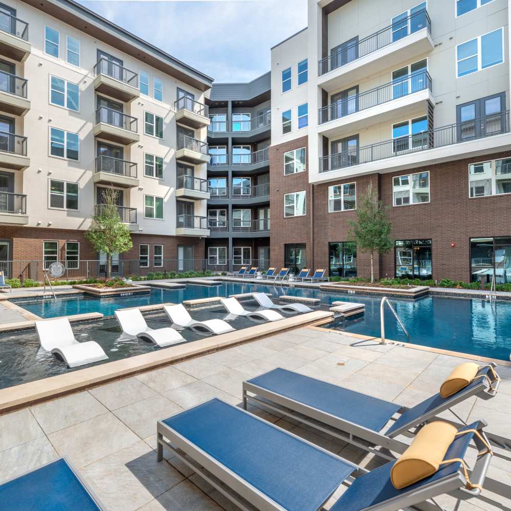 Lounge area beside the pool at Hall Street Flats in Dallas, Texas