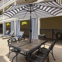 Lounge chairs with canopy near poolside at Lincoln Court Apartments in Dallas, Texas
