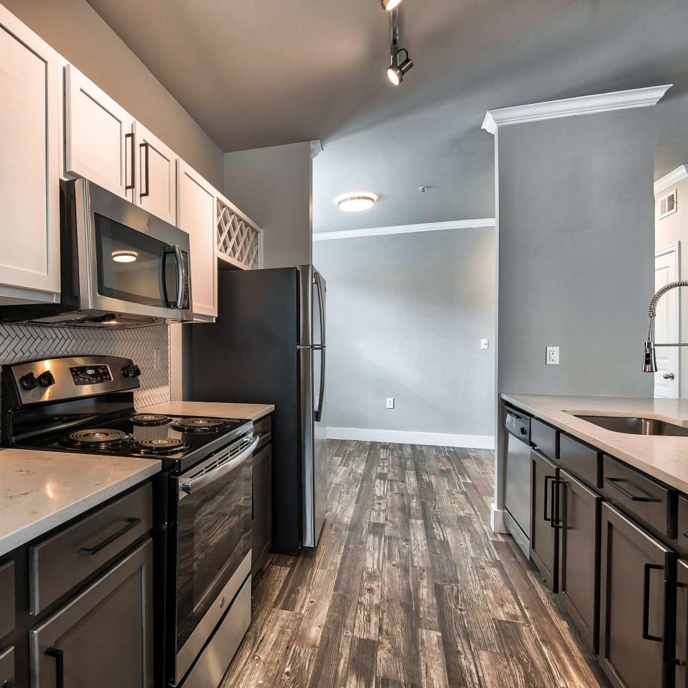 Fully equipped kitchen with stainless steel appliances at Asheville at Spring Branch in Houston, Texas