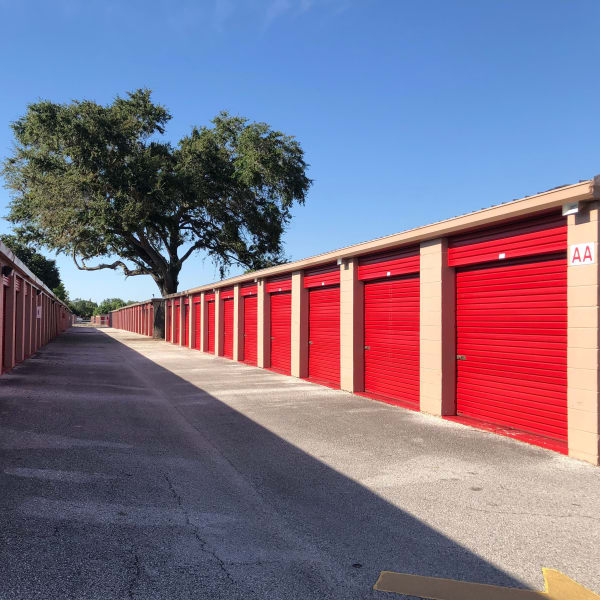 Outdoor storage units with red doors at StorQuest Self Storage in Tampa, Florida